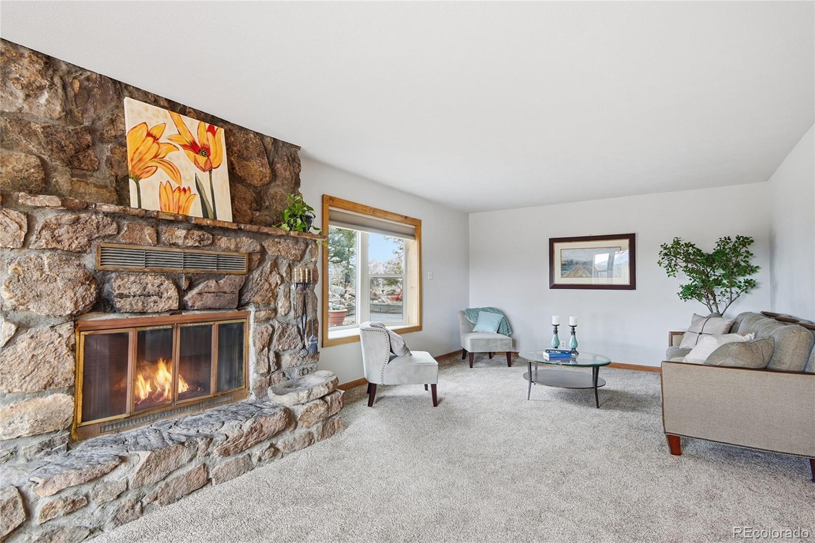 13082 South Wamblee Valley Road Conifer, CO 80433 - Photo 4 of 35 a living room with furniture a fireplace and a flat screen tv