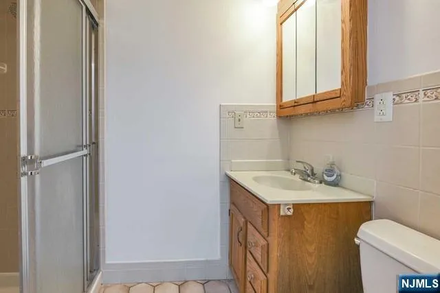 a bathroom with a sink toilet and mirror