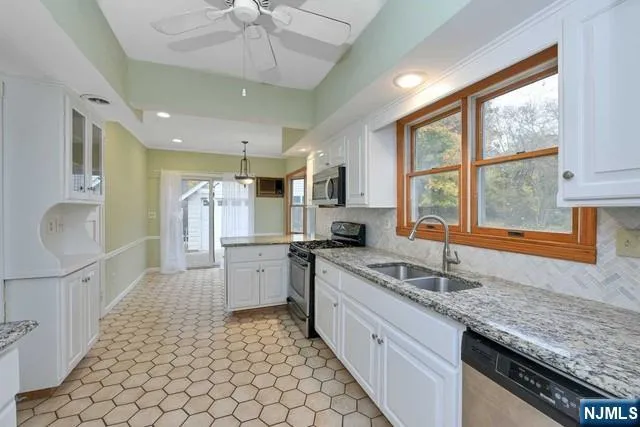 a kitchen with a sink stove and cabinets