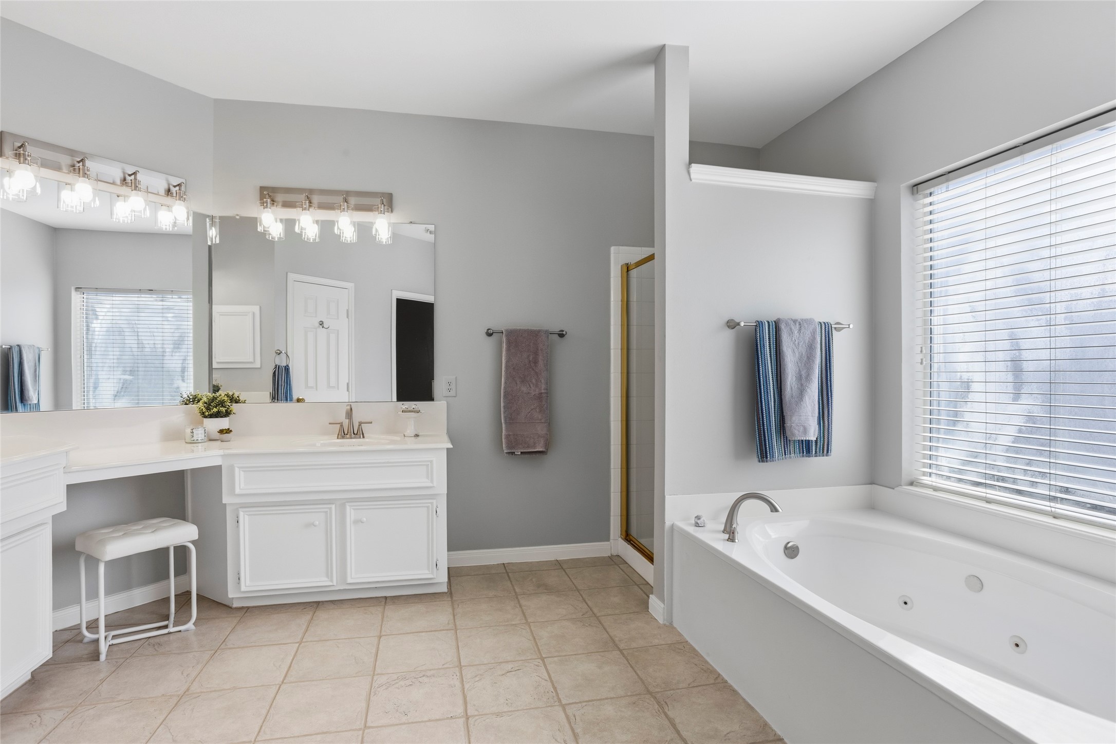 1131 Windsor Chase Lane Spring, TX 77373 - Photo 16 of 39 a bathroom with a bathtub a mirror a double vanity sinks and a shower