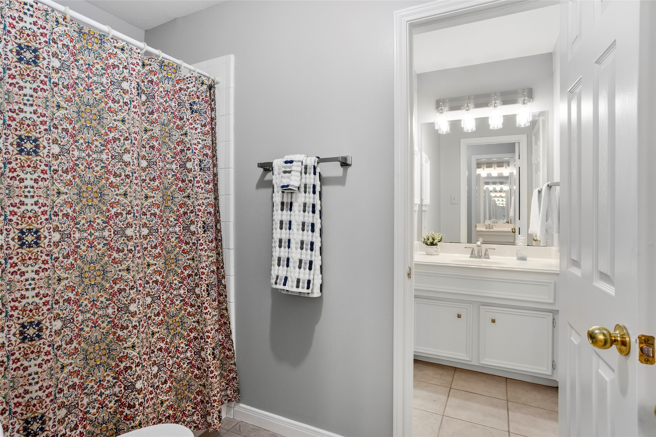 1131 Windsor Chase Lane Spring, TX 77373 - Photo 32 of 39 a bathroom with a shower curtain and a sink