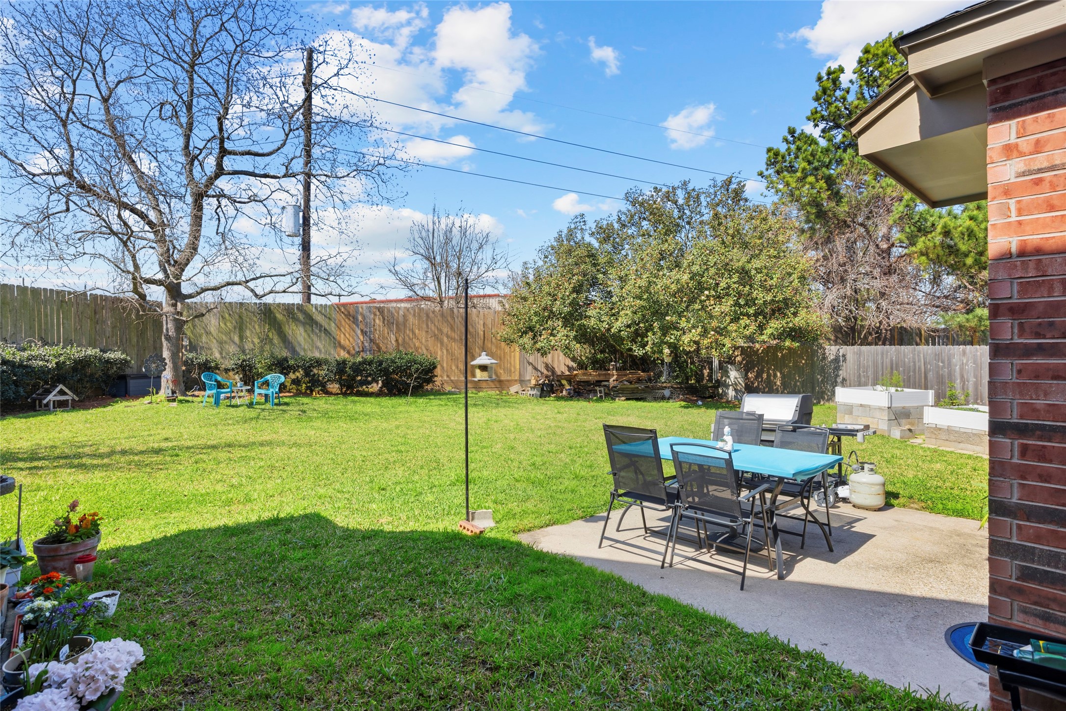 1131 Windsor Chase Lane Spring, TX 77373 - Photo 33 of 39 a view of a patio with table and chairs potted plants and large tree