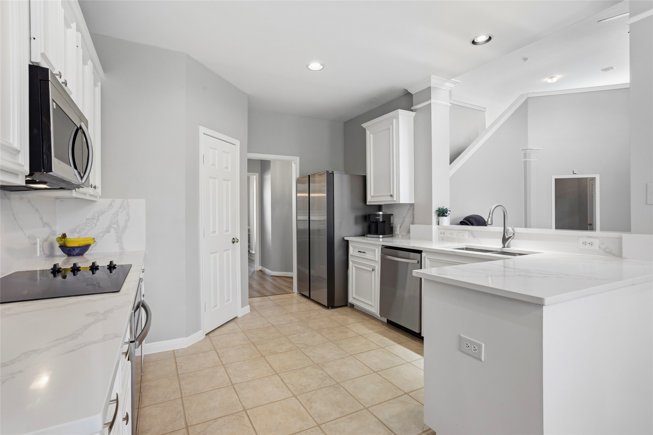 1131 Windsor Chase Lane Spring, TX 77373 - Photo 10 of 39 a kitchen with stainless steel appliances kitchen island granite countertop a refrigerator and a sink