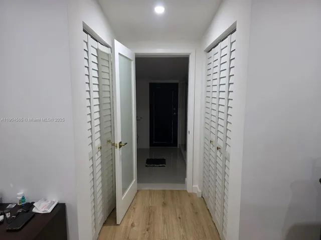 a bedroom with a large bed and a mirror