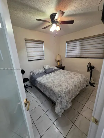 a bed room with a bed window and mirror