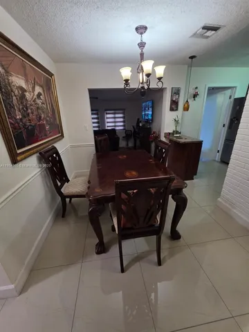 a kitchen with refrigerator and cabinets