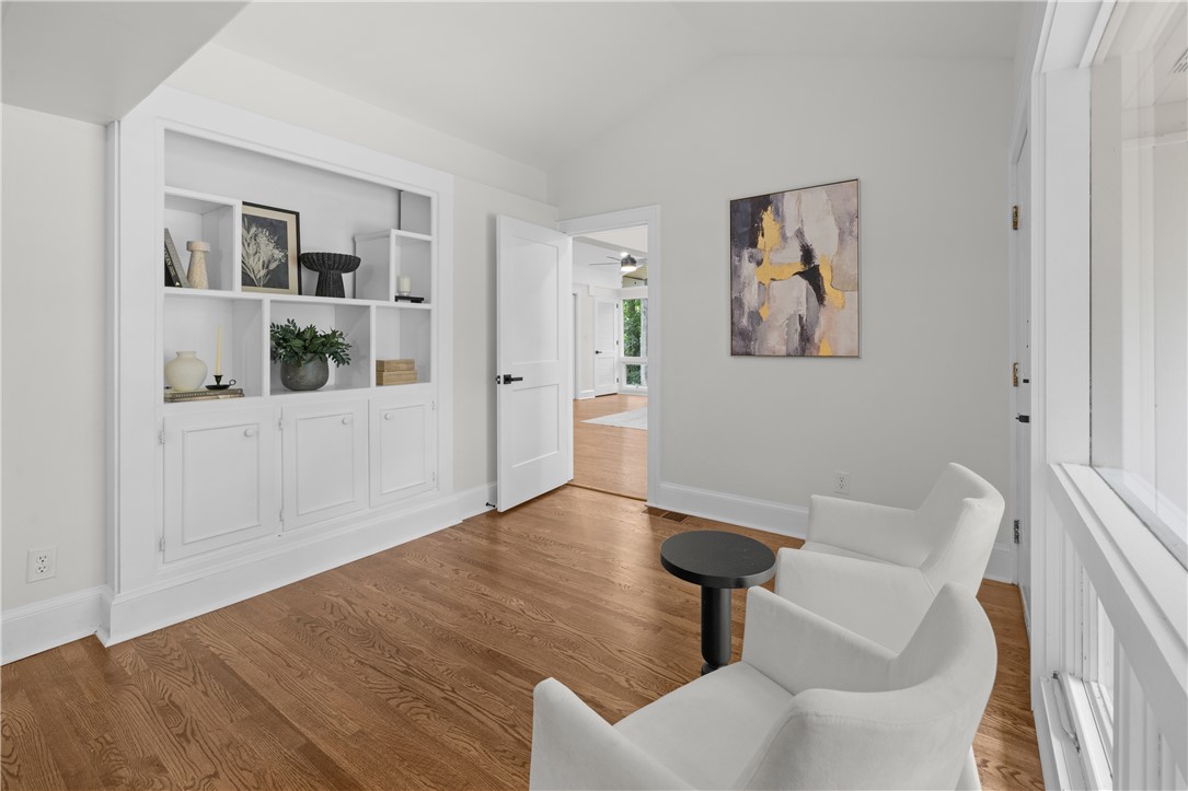 251 Riggs Drive Clemson, SC 29631 - Photo 17 of 37 Rich hardwood floors and tailored built-in shelving define this versatile modern sitting room.