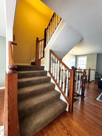 a view of entryway and hall with wooden floor