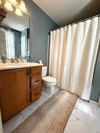 a view of a bathroom with sink and mirror