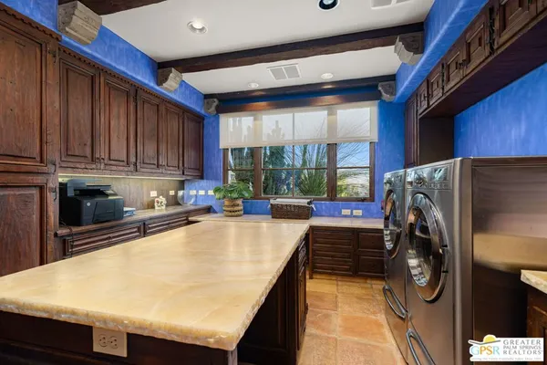 a bathroom with a granite countertop sink a mirror a vanity and shower