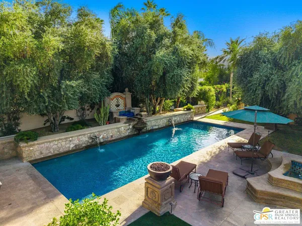 swimming pool with outdoor seating and trees