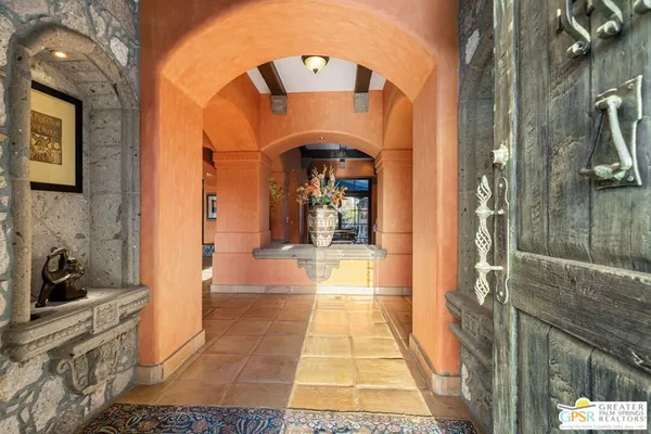 a living room with furniture a fireplace and a large window