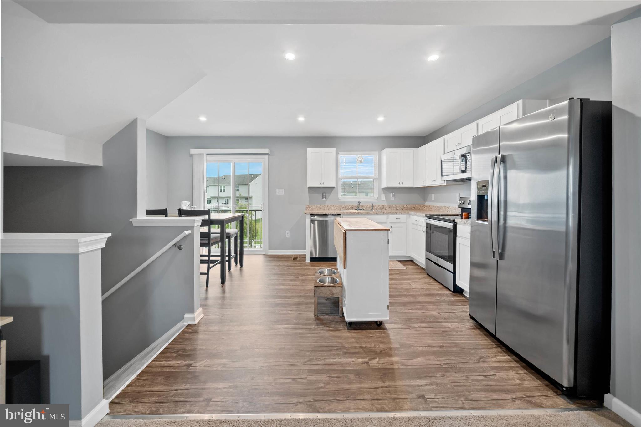 309 Mingo Way Townsend, DE 19734 - Photo 11 of 34 a kitchen with stainless steel appliances a refrigerator a stove top oven and white cabinets