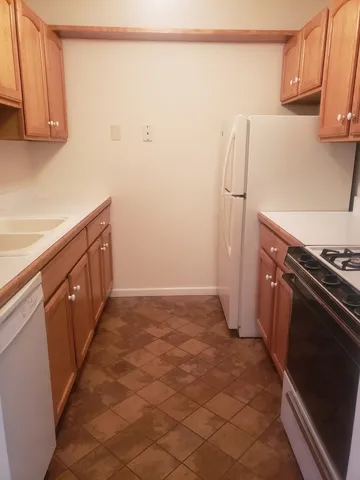 a stove top oven sitting inside of a kitchen