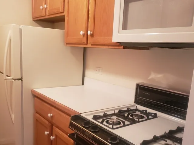 a stove top oven sitting inside of a kitchen