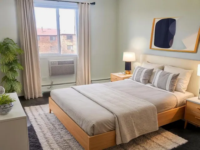 a bedroom with bed and window