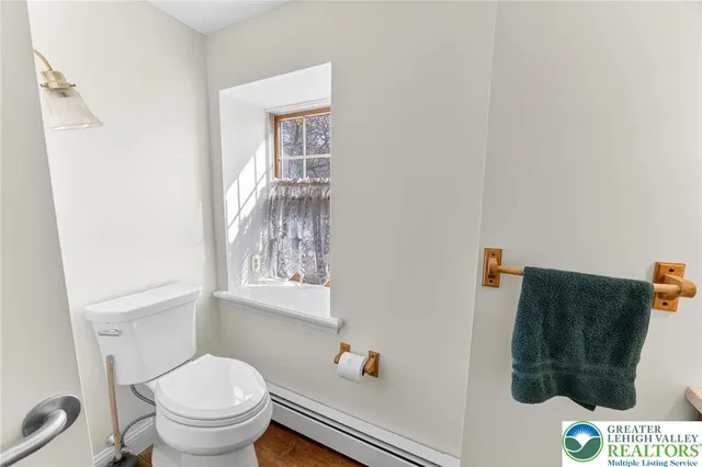 a bathroom with a toilet and a shower curtain