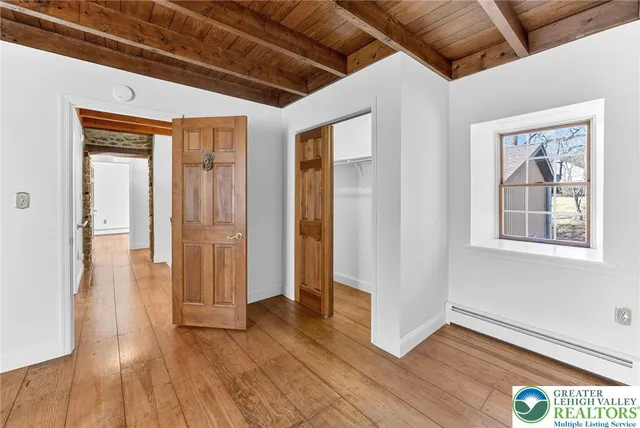 a view of empty room with wooden floor