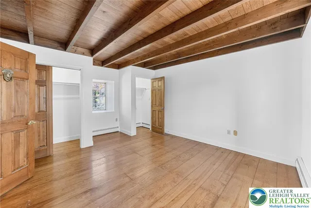 a view of an empty room with wooden floor