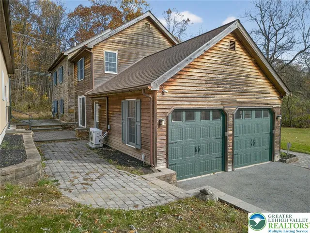 a view of a house with a yard and garage