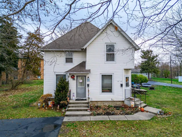 a front view of a house with a yard