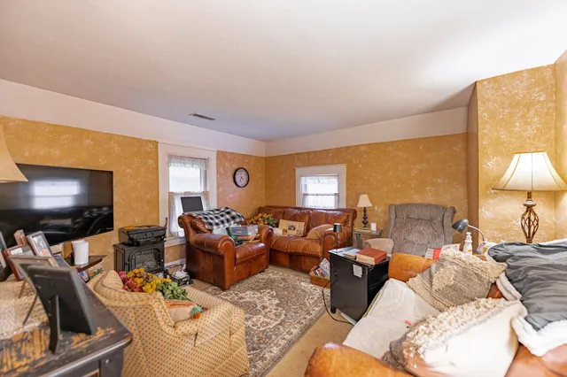a living room with furniture and a rug