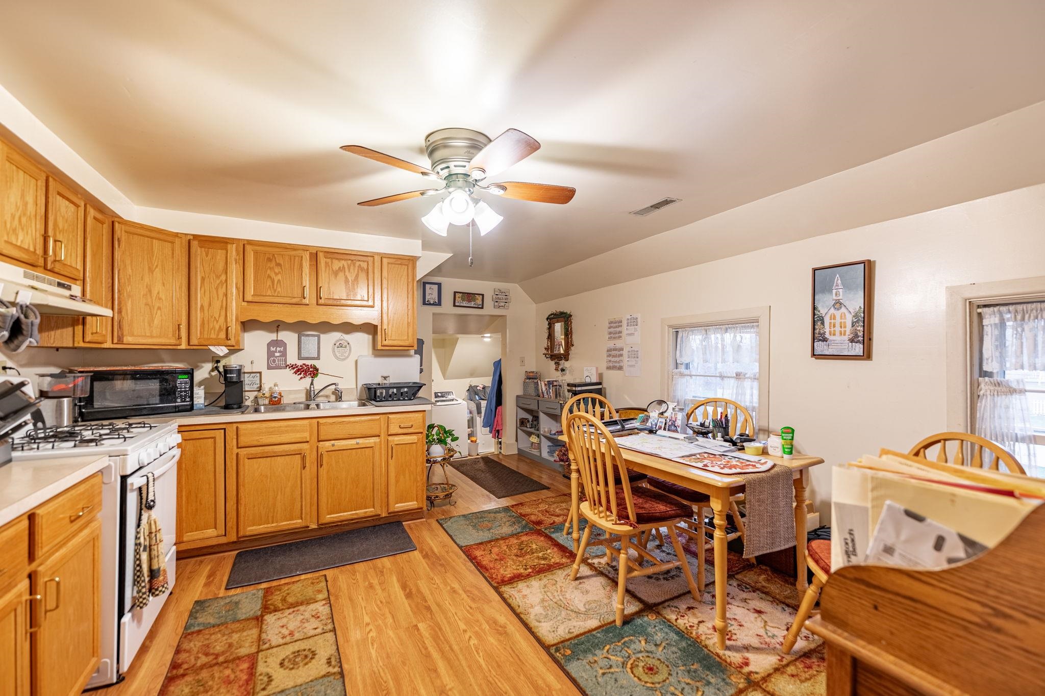 917 West Locust Street Belvidere, IL 61008 - Photo 19 of 59 a living room with stainless steel appliances kitchen island granite countertop furniture and a kitchen view