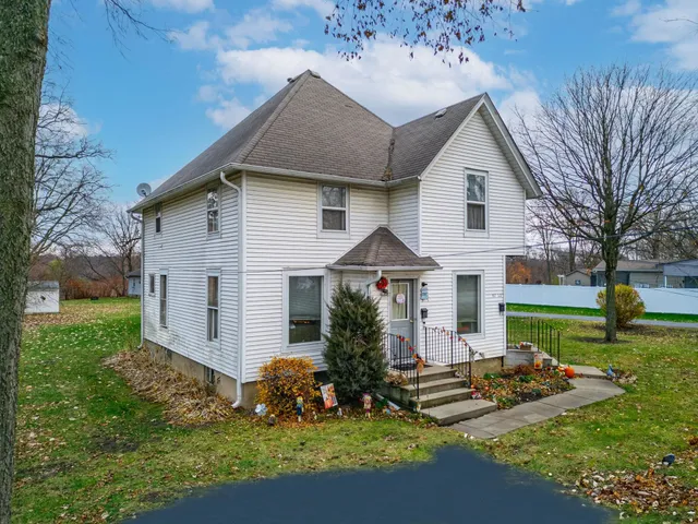 a front view of house with yard and green space