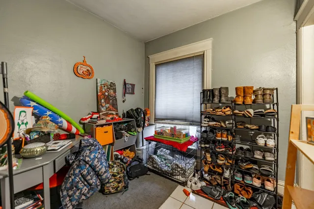 a kitchen with stainless steel appliances kitchen island granite countertop a dining table chairs refrigerator and sink