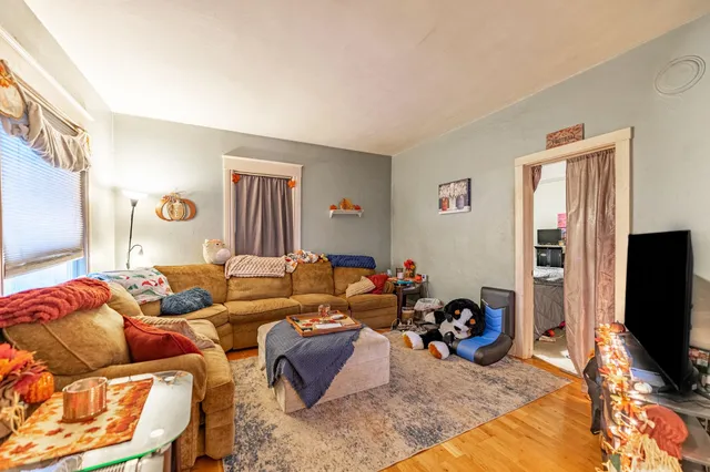 a dining room with furniture entryway and wooden floor