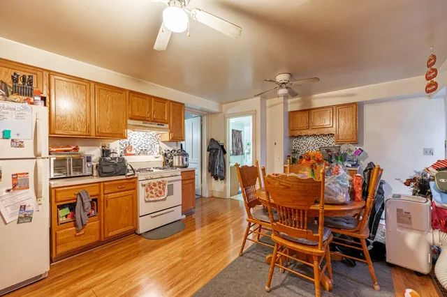 a living room with furniture flat screen tv and lamp