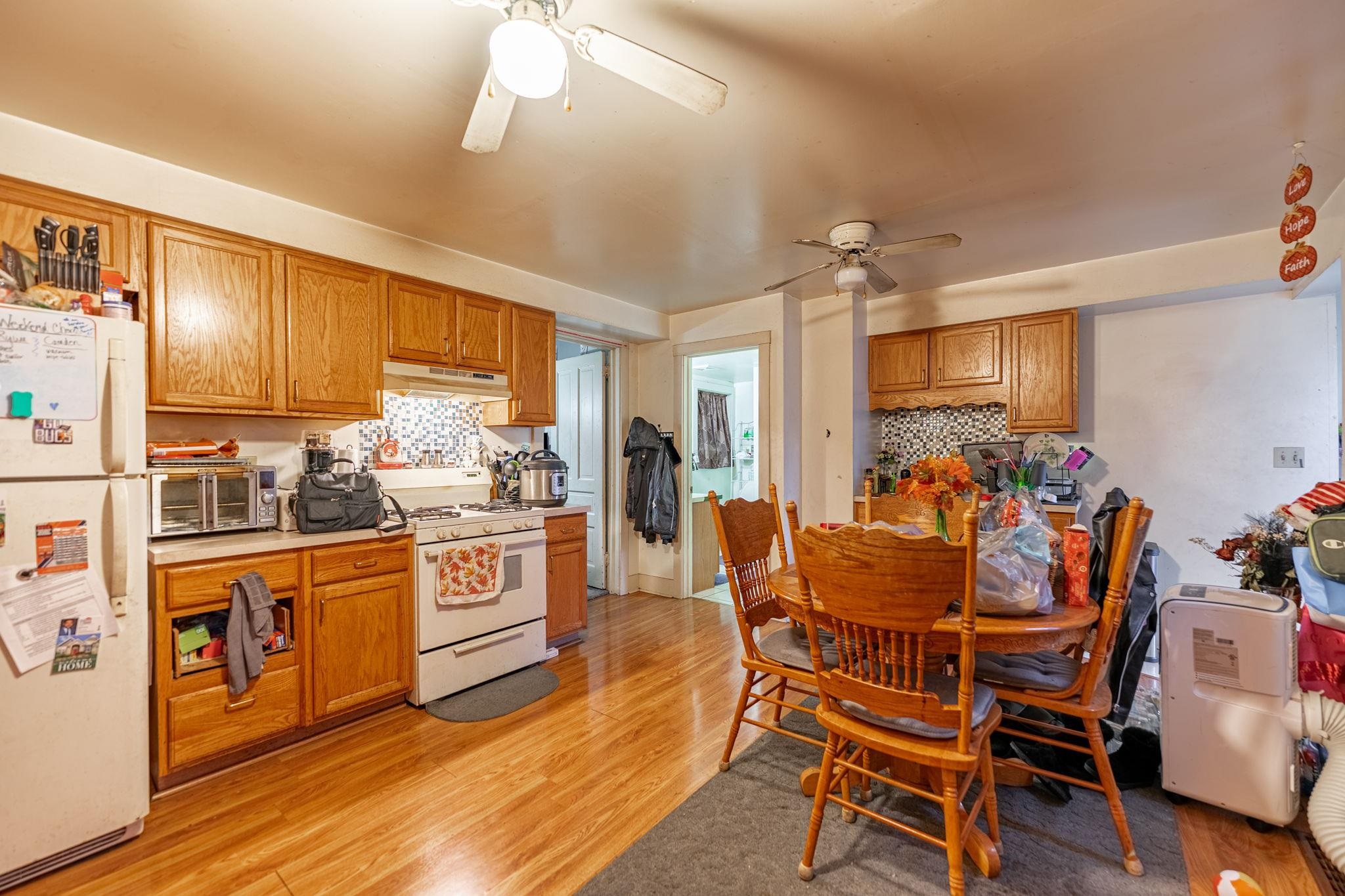 917 West Locust Street Belvidere, IL 61008 - Photo 7 of 59 a kitchen with stainless steel appliances kitchen island granite countertop a dining table chairs refrigerator and sink