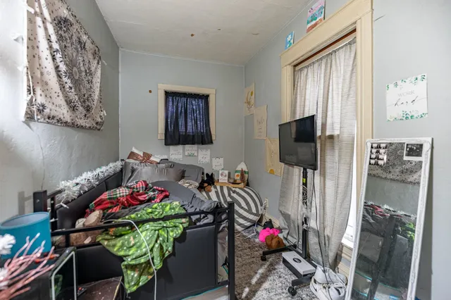 a front view of house with yard and trees in the background