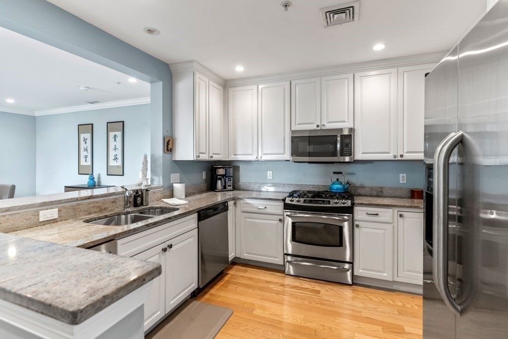 39 Intrepid Circle, Unit 302 Marblehead, MA 01945 - Photo 11 of 32 a kitchen with a sink stove and cabinets