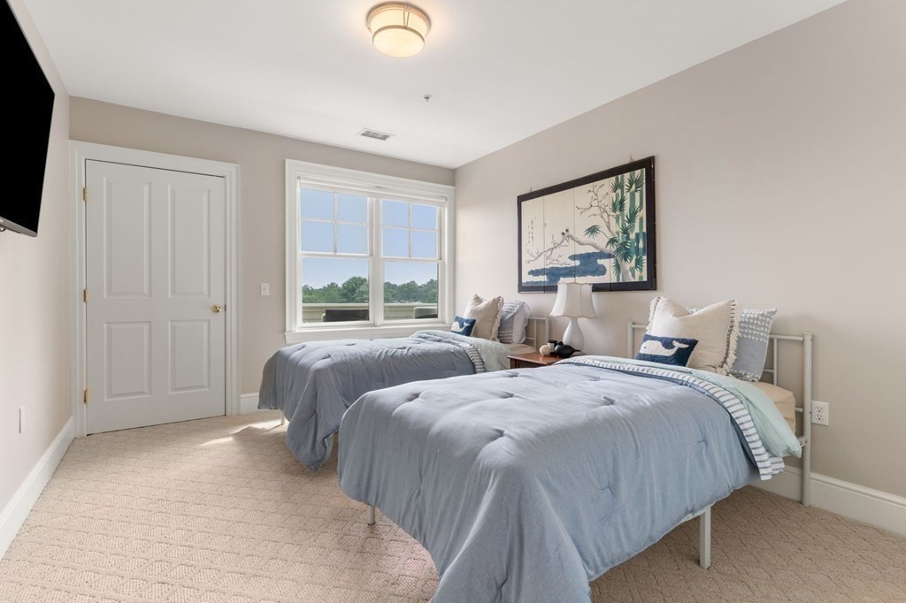 39 Intrepid Circle, Unit 302 Marblehead, MA 01945 - Photo 12 of 32 a bed room with two beds and a window