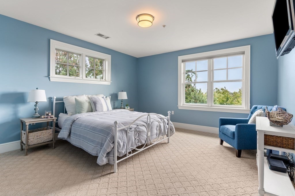 39 Intrepid Circle, Unit 302 Marblehead, MA 01945 - Photo 15 of 32 a bedroom with a bed and a window