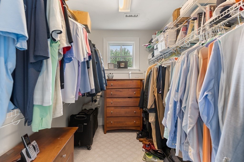 39 Intrepid Circle, Unit 302 Marblehead, MA 01945 - Photo 17 of 32 a view of walk in closet with clothes and shoes