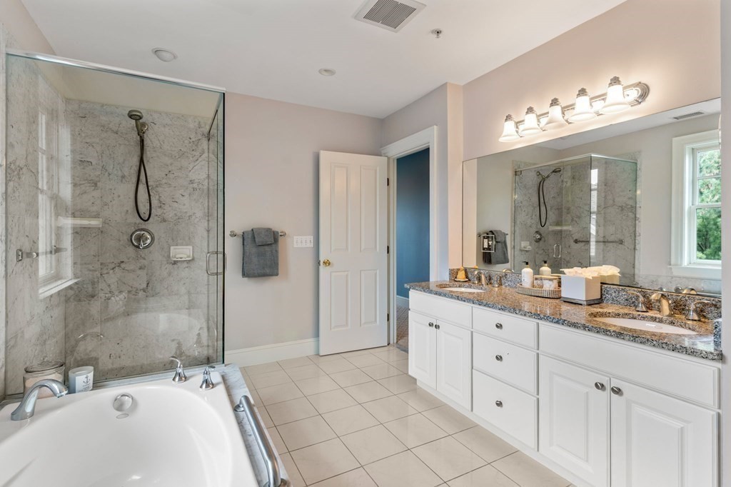 39 Intrepid Circle, Unit 302 Marblehead, MA 01945 - Photo 19 of 32 a bathroom with a sink double vanity granite tub shower and a mirror