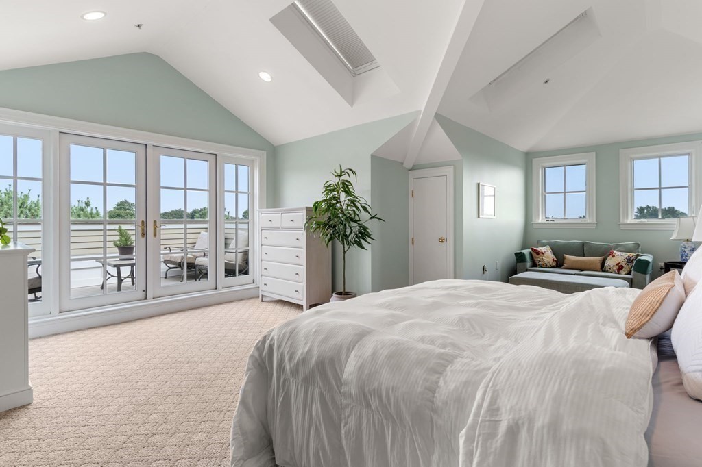 39 Intrepid Circle, Unit 302 Marblehead, MA 01945 - Photo 21 of 32 a spacious bedroom with a large bed and large windows