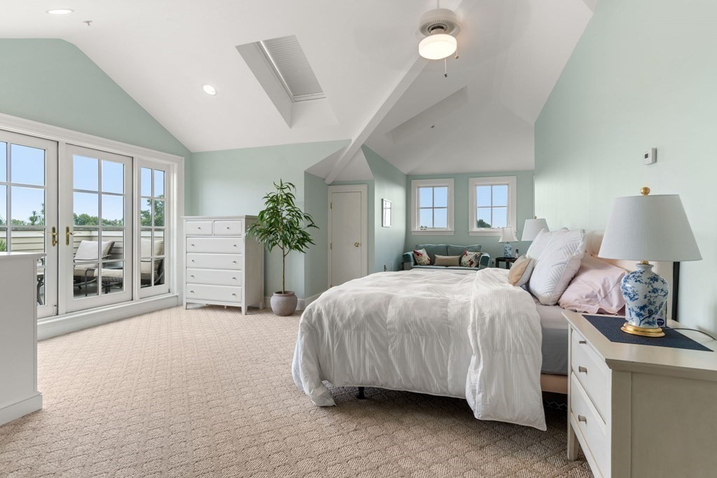 39 Intrepid Circle, Unit 302 Marblehead, MA 01945 - Photo 22 of 32 a spacious bedroom with a large bed and a large window