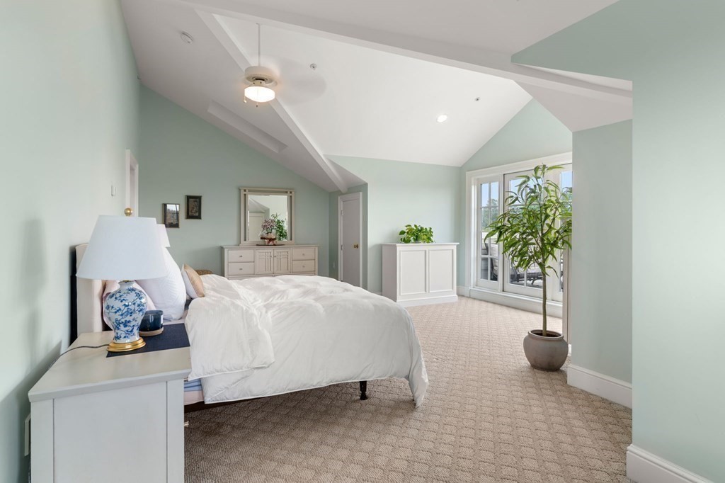 39 Intrepid Circle, Unit 302 Marblehead, MA 01945 - Photo 23 of 32 a bed room with a bed and a potted plant