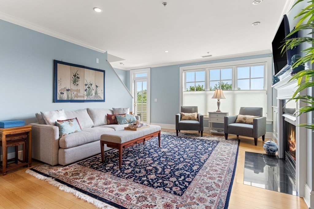 39 Intrepid Circle, Unit 302 Marblehead, MA 01945 - Photo 3 of 32 a living room with furniture large rug a flat screen tv and a rug
