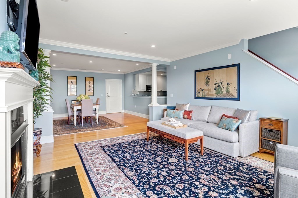 39 Intrepid Circle, Unit 302 Marblehead, MA 01945 - Photo 4 of 32 a living room with furniture and a fireplace