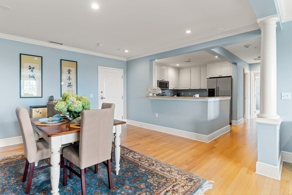 39 Intrepid Circle, Unit 302 Marblehead, MA 01945 - Photo 8 of 32 a kitchen with a table chairs and microwave