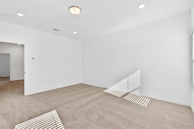 a view of a room with wooden floor and white walls