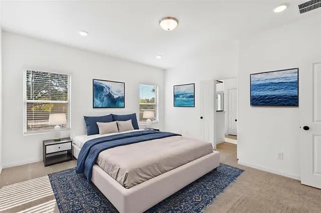 a spacious bedroom with a large bed and a window