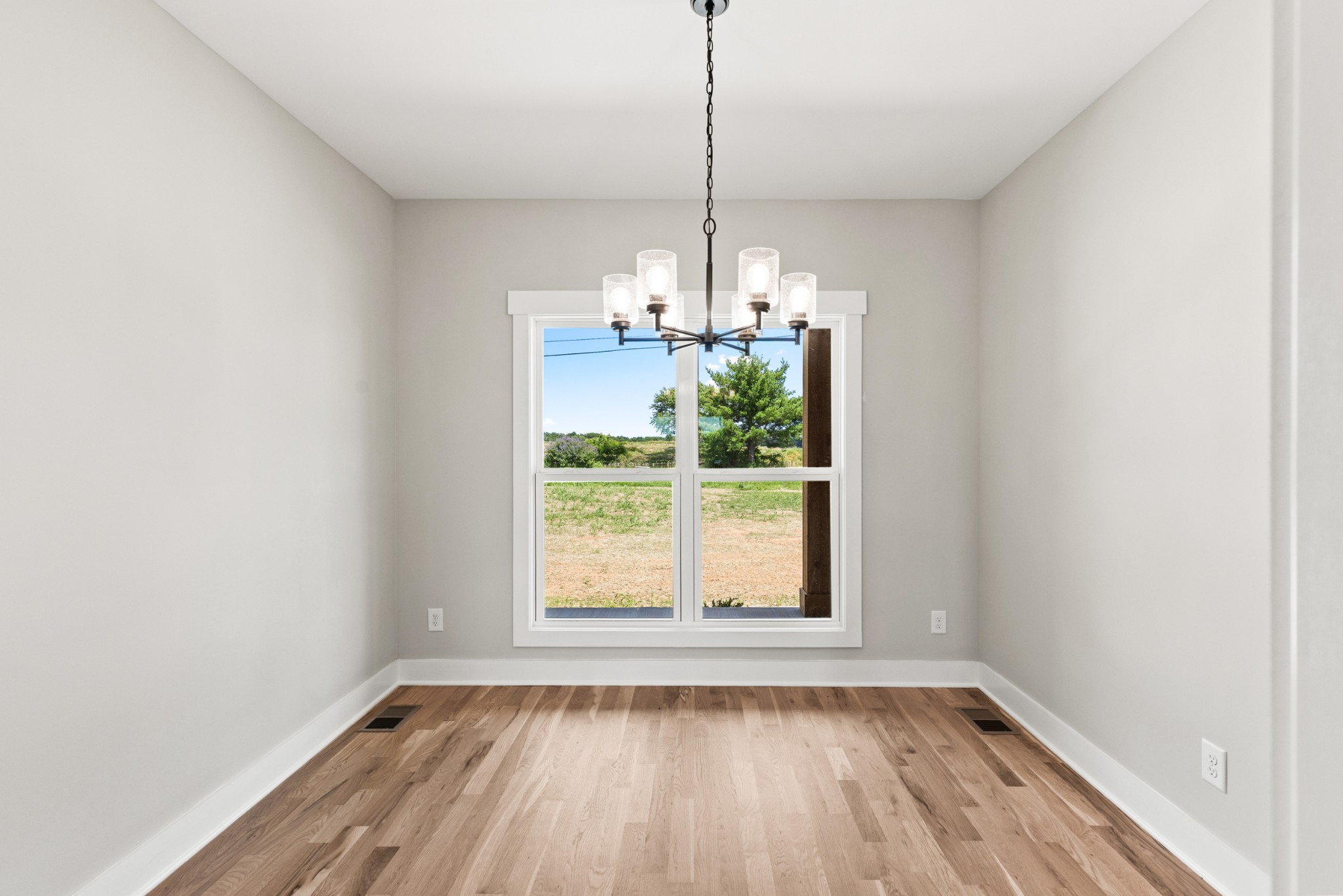 5638 Borthick Road Springfield, TN 37172 - Photo 16 of 43 a view of a room with wooden floor chandeliers and kitchen view