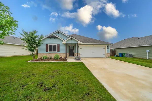 a front view of house with yard and green space