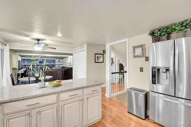 a kitchen with stainless steel appliances granite countertop a refrigerator and a sink