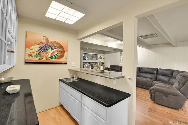 a kitchen with stainless steel appliances a stove a sink and a refrigerator